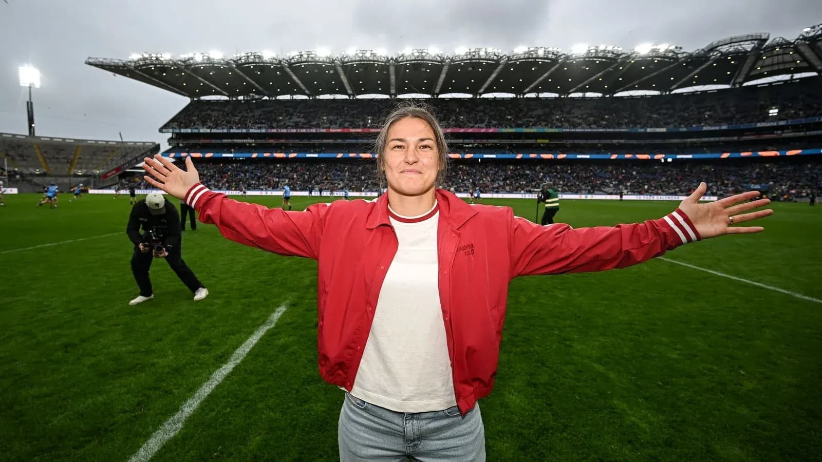 Woman with arms outstretched on rugby field