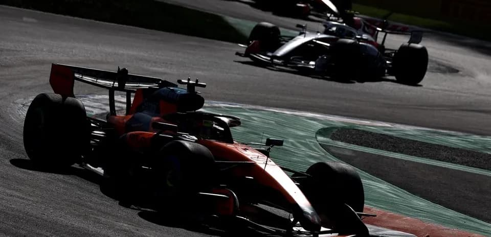 Formula 1 cars racing on a track during a race