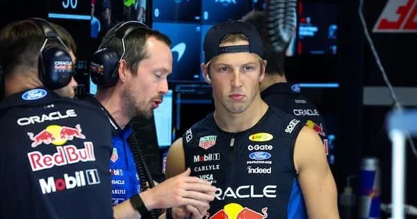 Team members discussing strategy in garage area