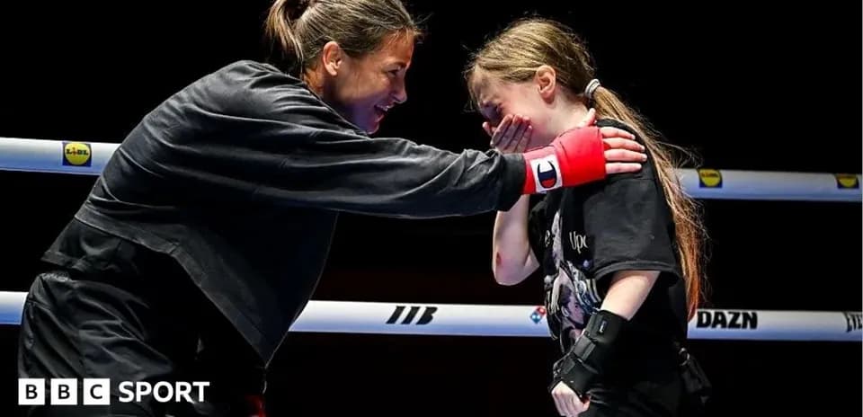 Boxer training with young girl in the ring