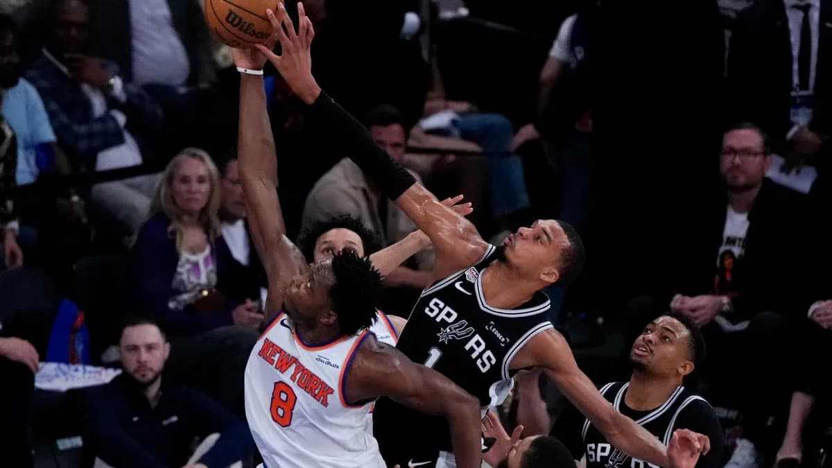 Player attempting to block shot during basketball game