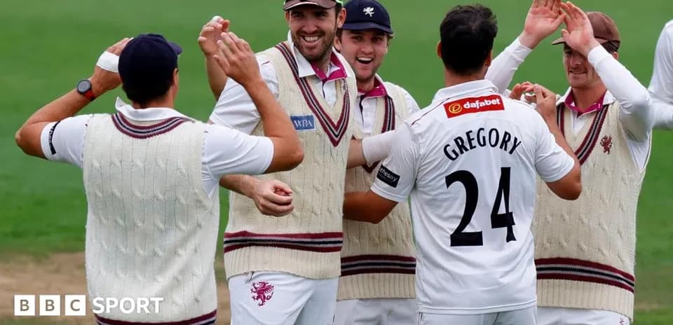Cricket team celebrating a wicket on the field
