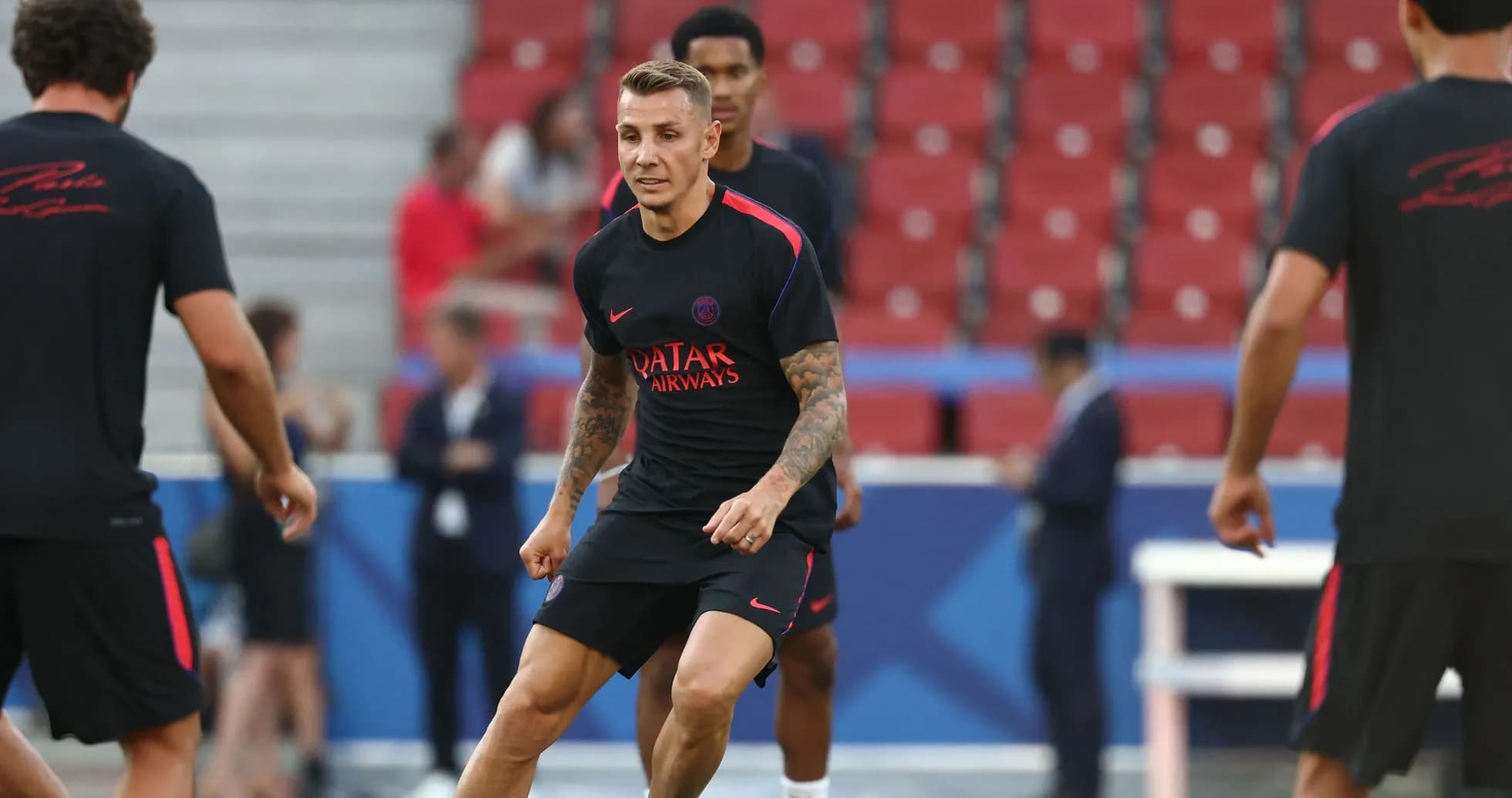 Player training on the pitch with teammates