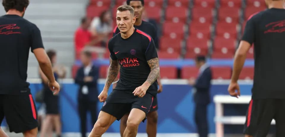 Player training on the pitch with teammates