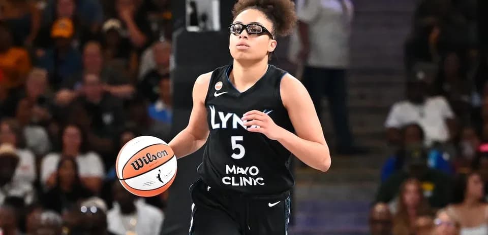 Player dribbling basketball during game in arena