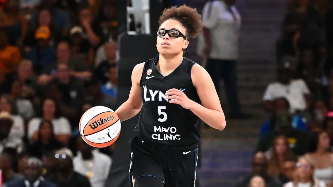 Player dribbling basketball during game in arena