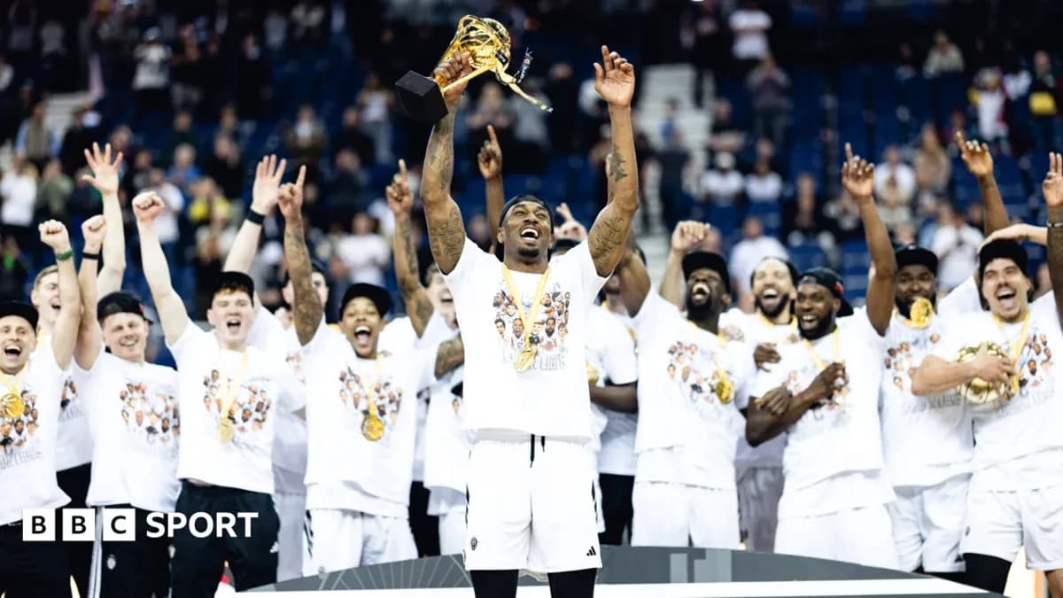 Player holding trophy with teammates celebrating victory