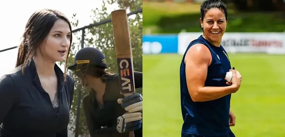 Two women in cricket gear on the field