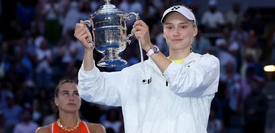 Player holding trophy with runner-up in background