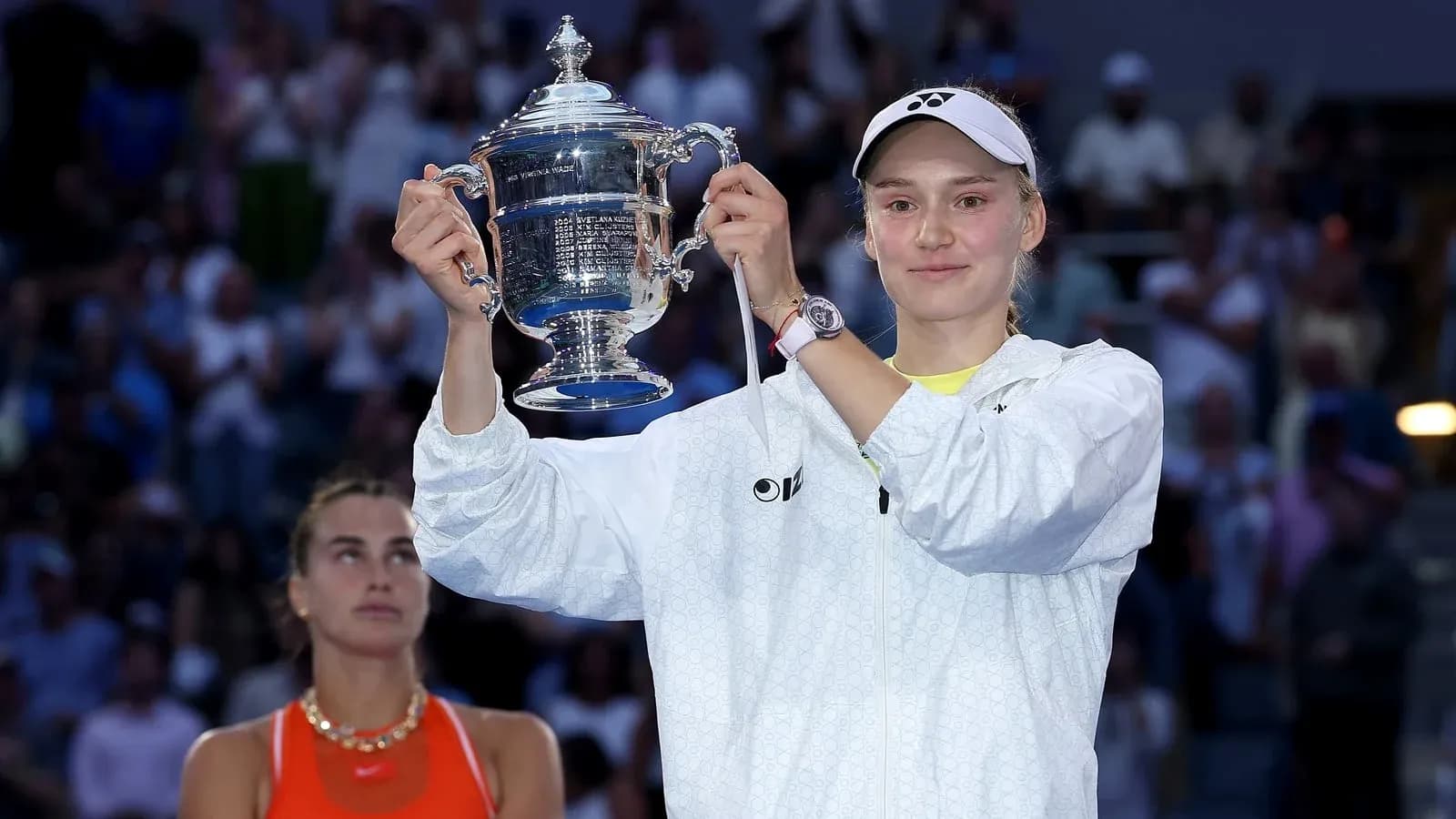 Player holding trophy with runner-up in background Player holding trophy with runner-up in background