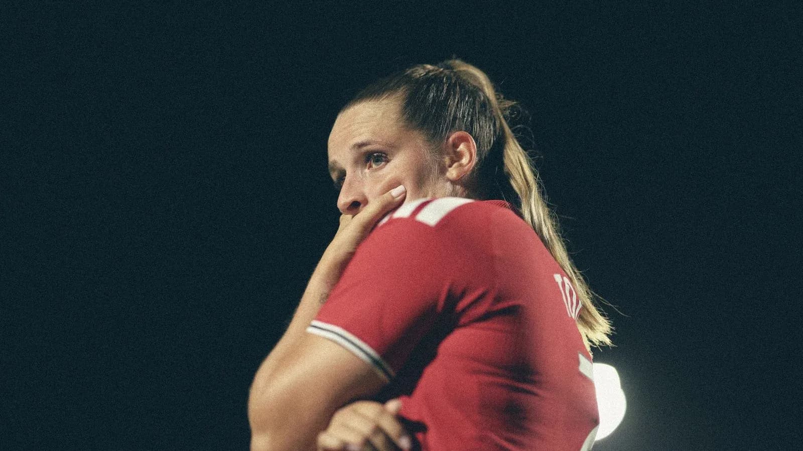 Player in red jersey during a night match