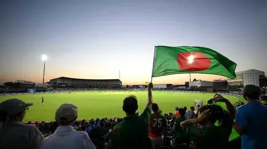 Fans waving Bangladesh flag during cricket match