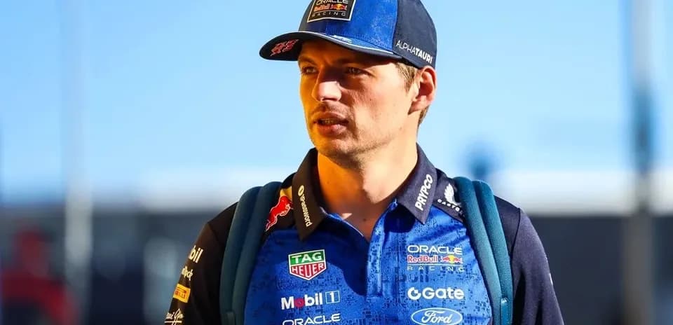 Driver wearing team shirt and cap walking outdoors