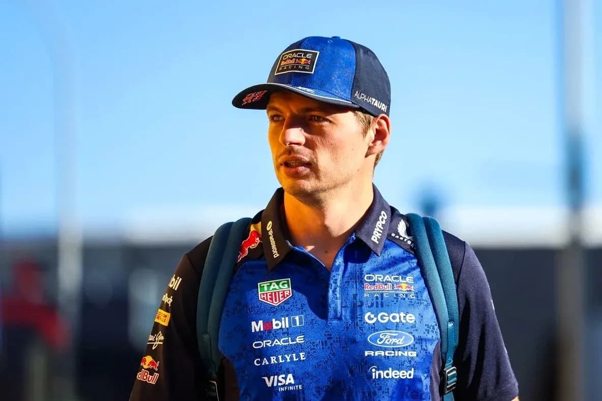 Driver wearing team shirt and cap walking outdoors