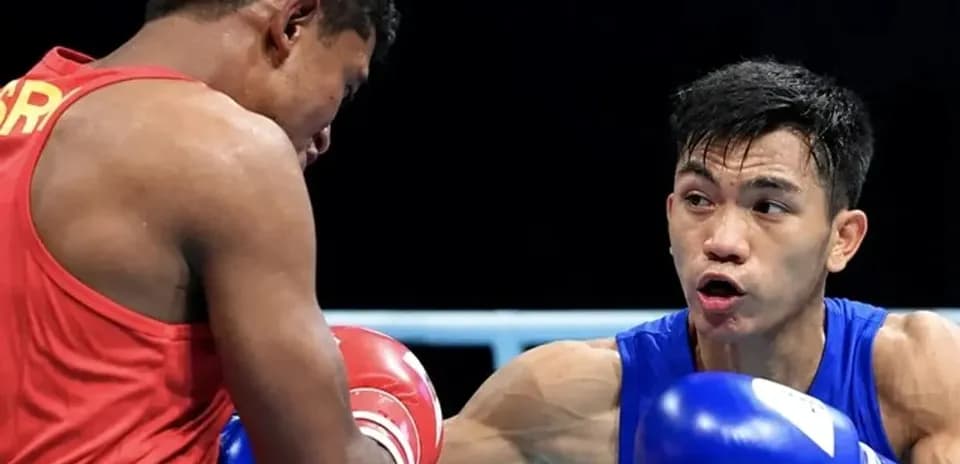 Two boxers competing in a match inside the ring