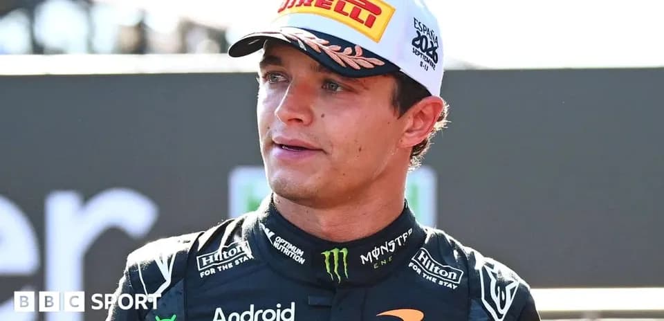 Driver wearing McLaren racing suit at event