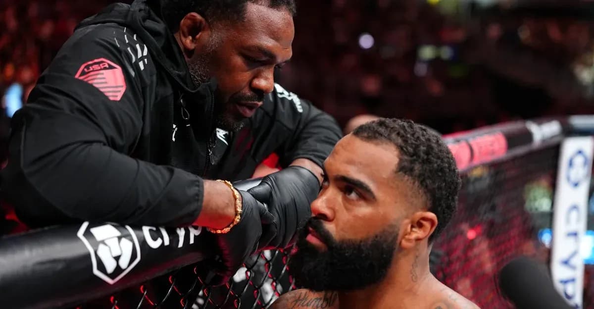 Coach giving instructions to fighter in octagon