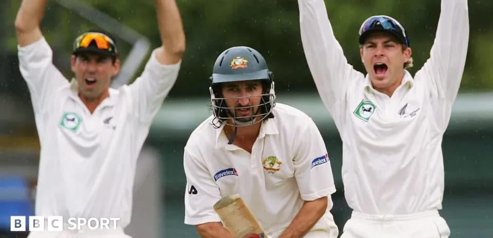 Batsman facing delivery with fielders celebrating behind