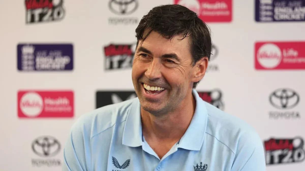 Coach smiling during press conference at venue