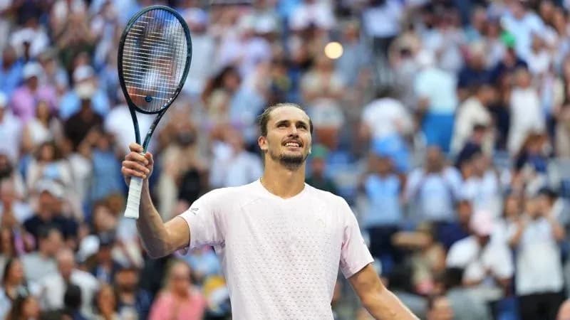 Player celebrating victory with racket raised in crowd