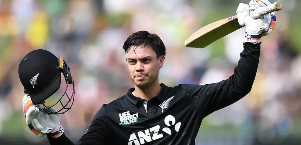 Cricketer celebrating a half-century with helmet raised
