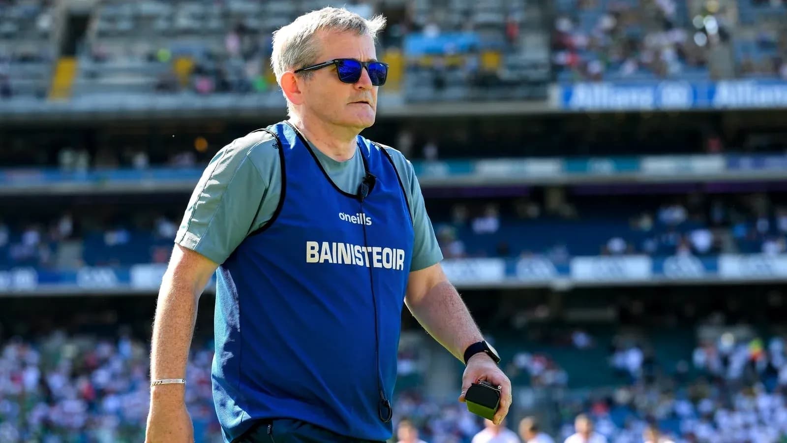 Coach wearing sunglasses during a match warm-up