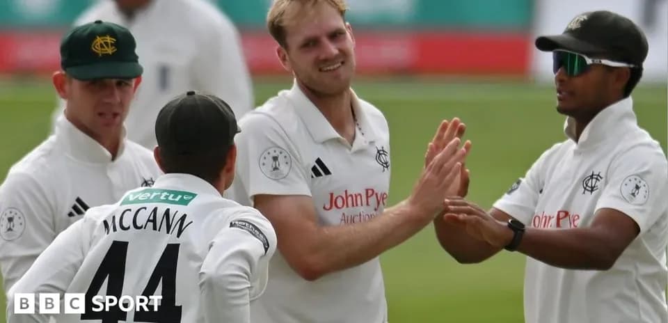 Cricket players celebrating a wicket on the field