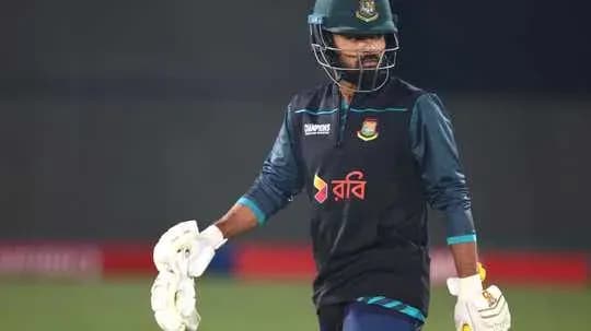 Cricketer in training gear walking on field