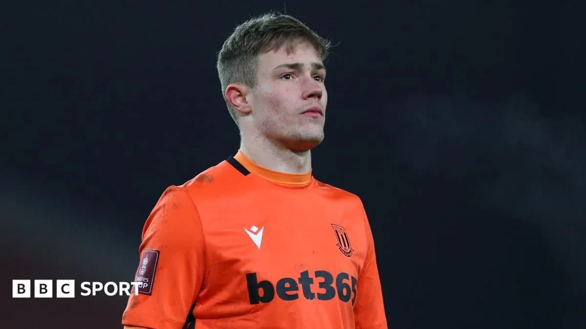 Goalkeeper in orange kit during match action