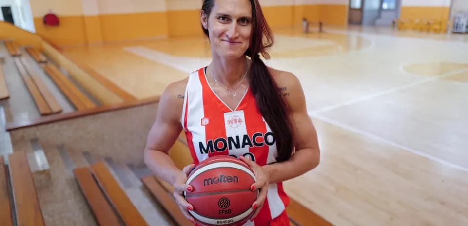 Player in Monaco jersey holding a basketball