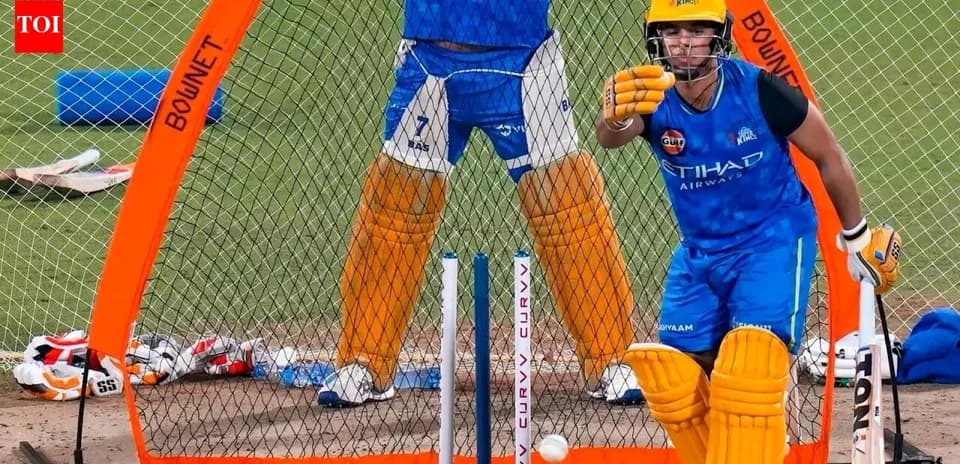 Batter practicing in nets with wicketkeeper behind