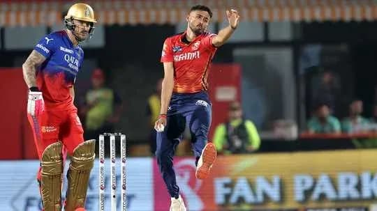 Bowler delivering ball while batsman prepares to play