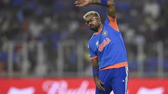 Cricketer waving during a match at the stadium