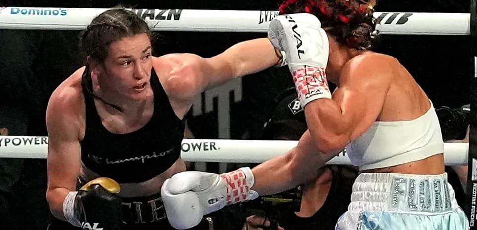 Two female boxers exchanging punches in the ring