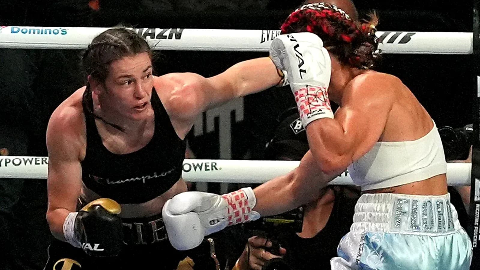 Two female boxers exchanging punches in the ring