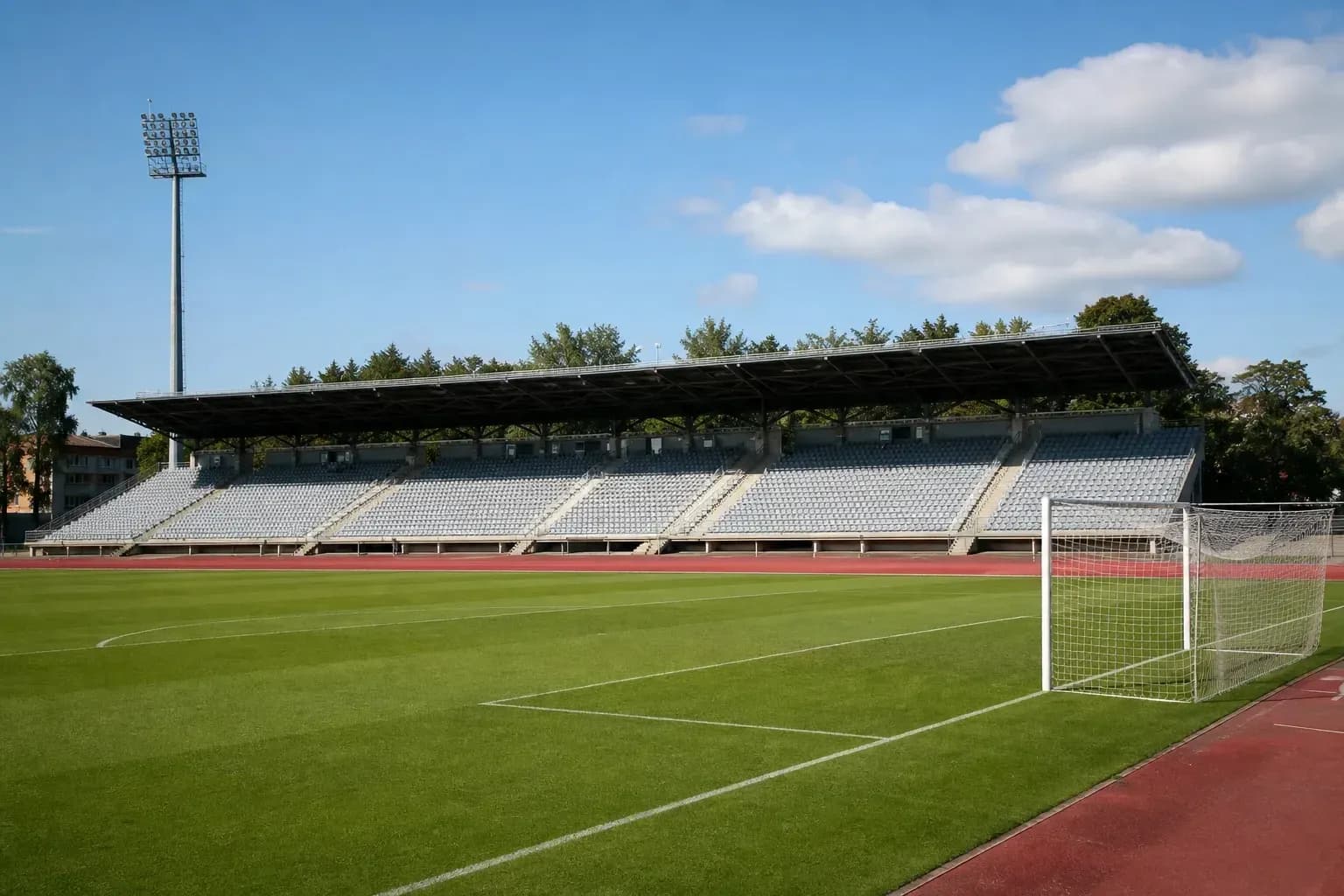 Empty football stadium with seating and goalpost