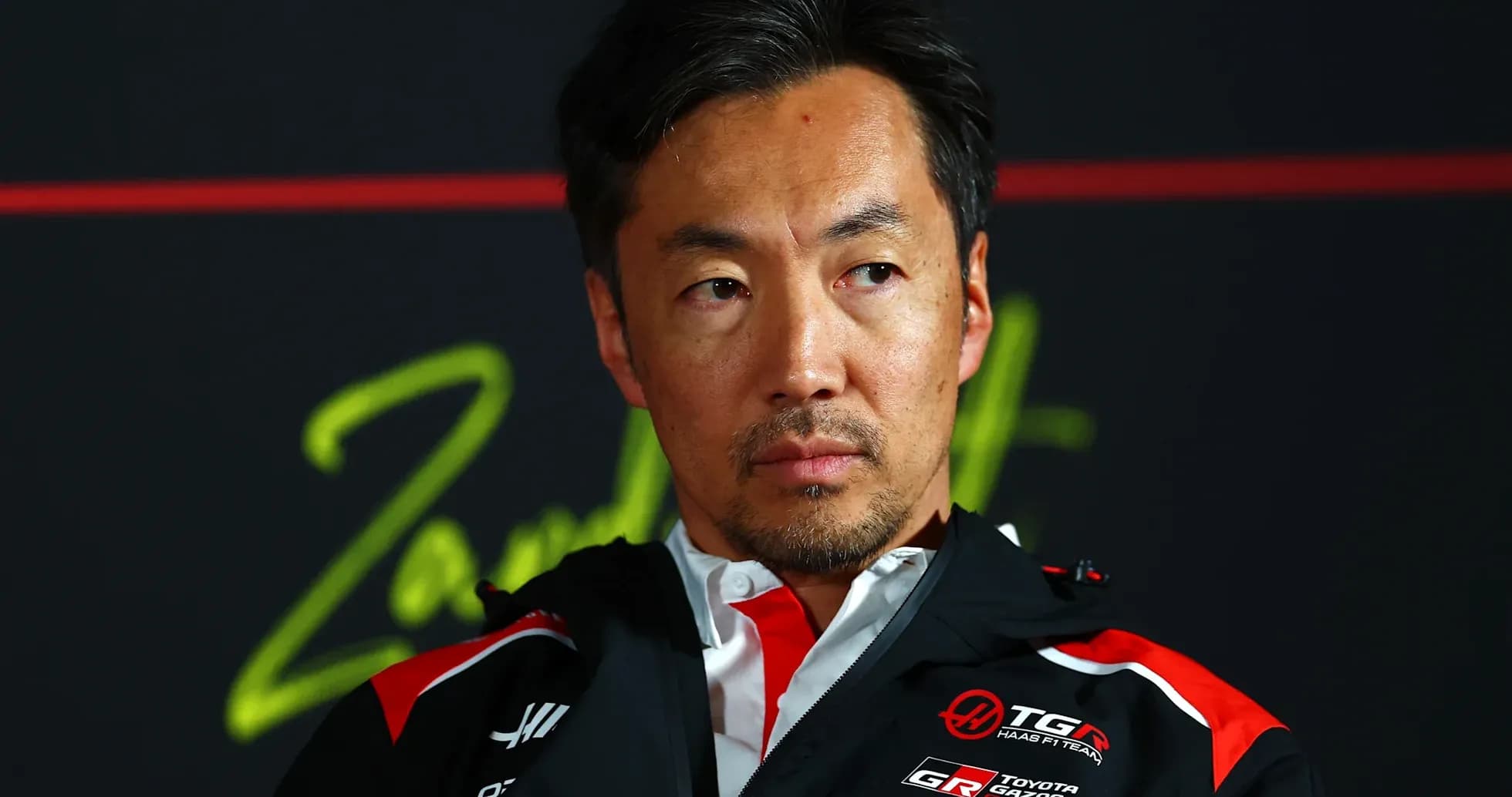Team manager during press conference with branding
