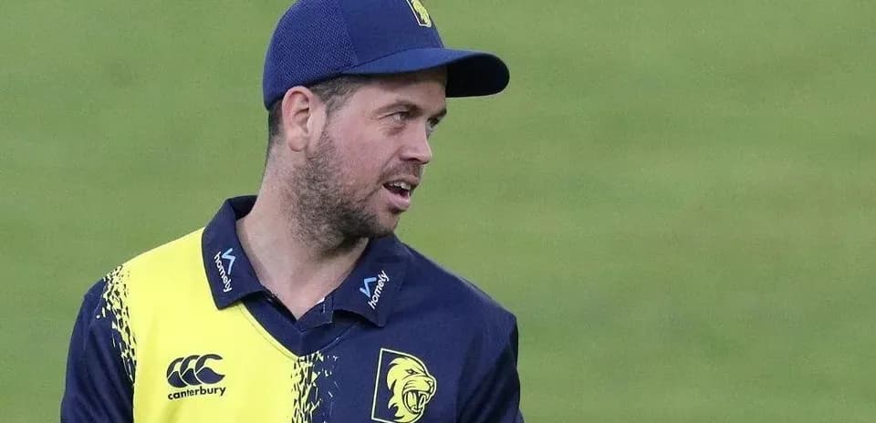 Cricketer in team uniform on the field