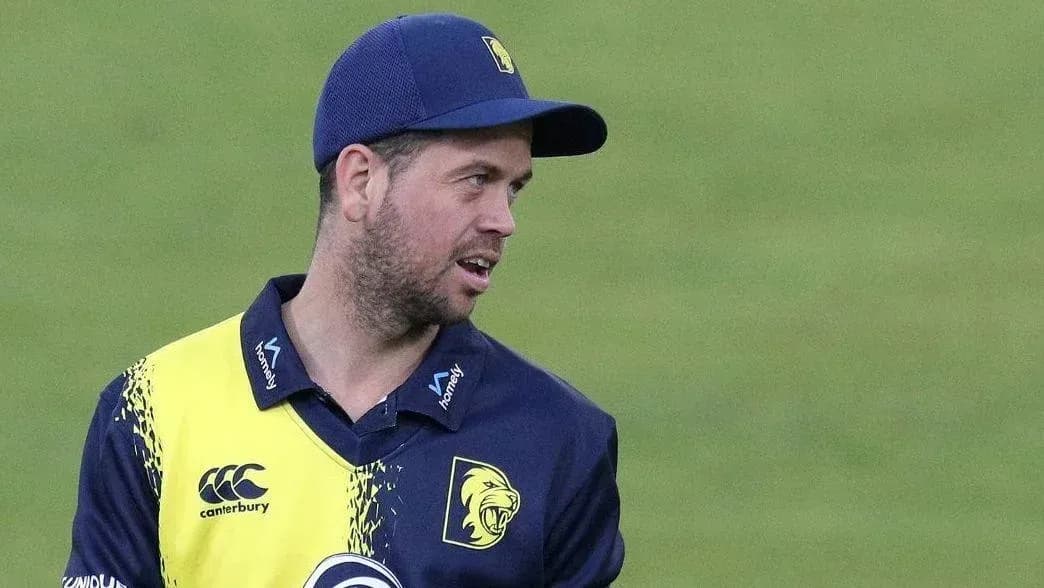 Cricketer in team uniform on the field