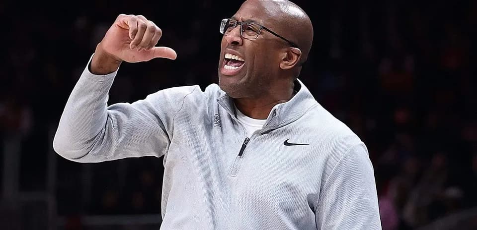 Coach gesturing and shouting during basketball game