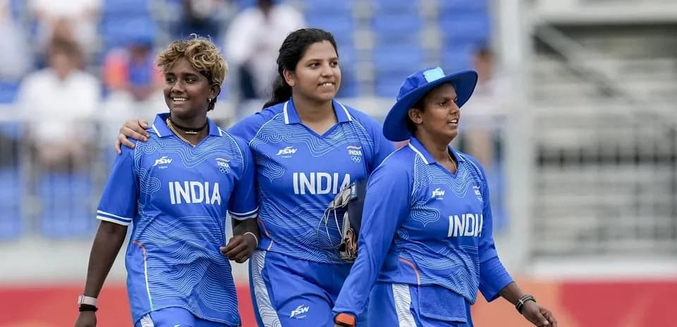 Three Indian cricketers walking off the field