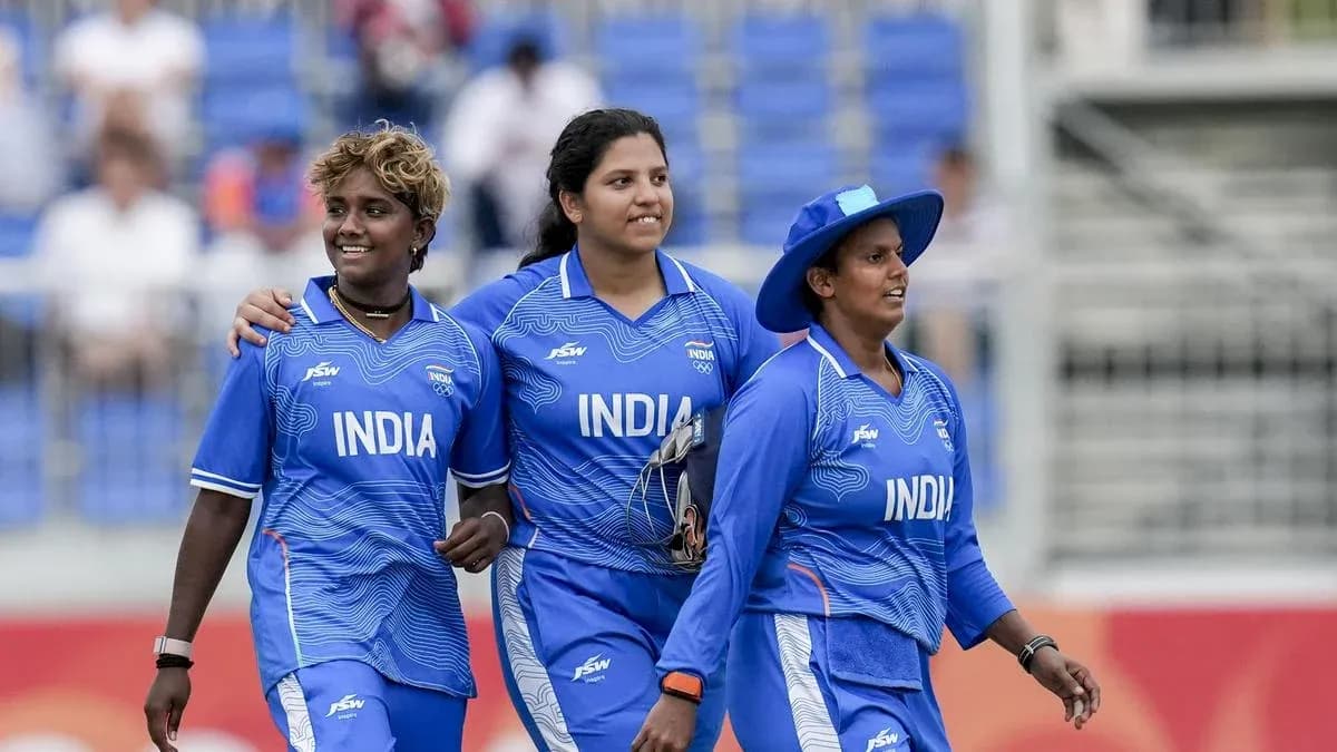 Three Indian cricketers walking off the field