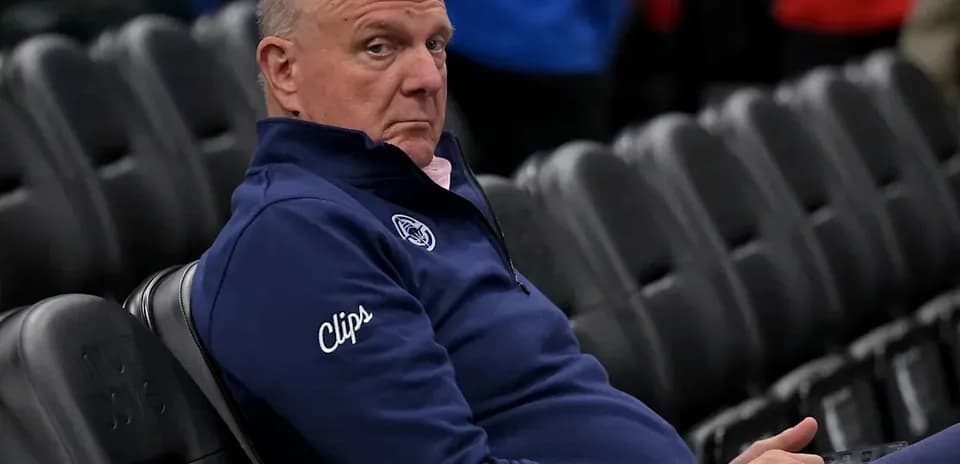 Man sitting in empty arena wearing Clippers apparel