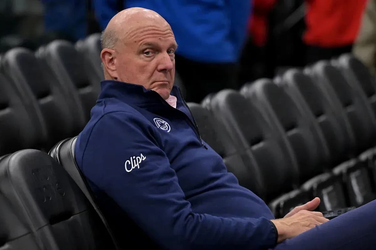 Man sitting in empty arena wearing Clippers apparel