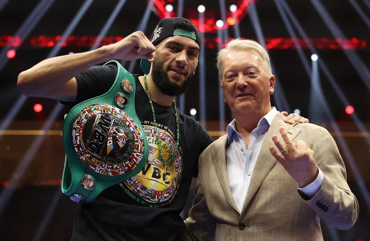 Boxer celebrating with championship belt and promoter