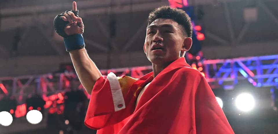 Boxer celebrating victory while holding up hand