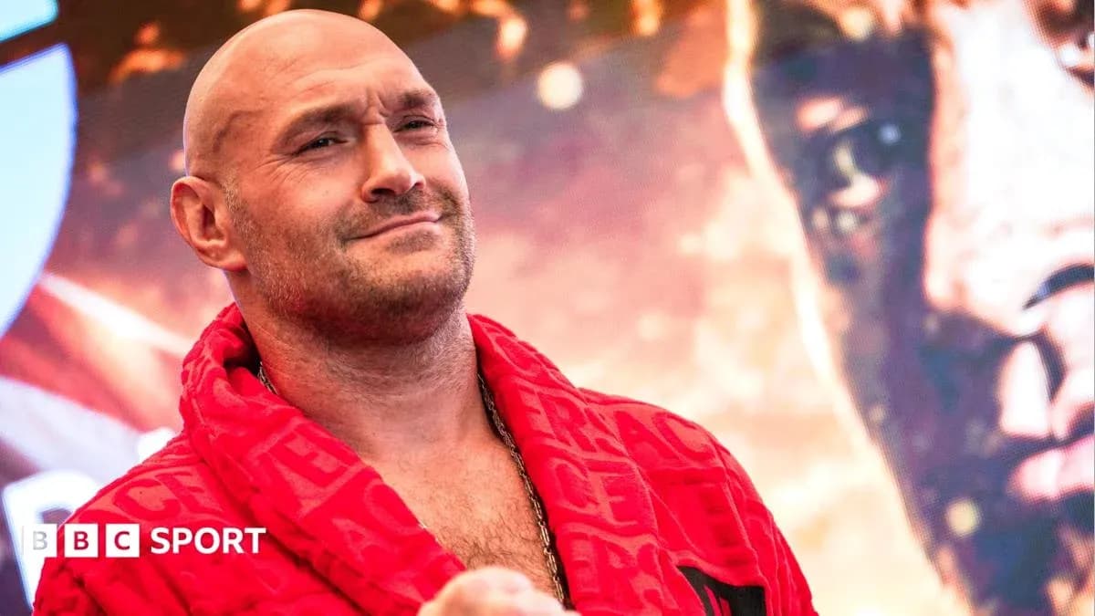 Boxer wearing red robe at promotional event