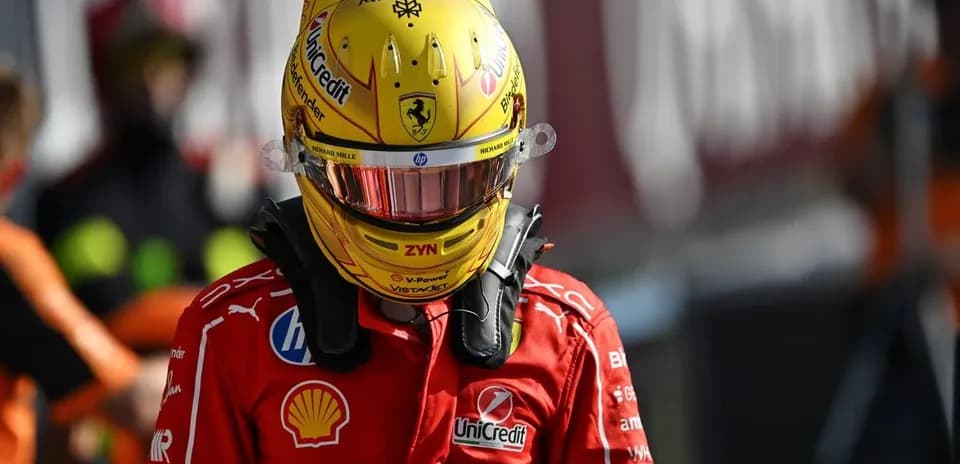 Racing driver in Ferrari uniform and helmet