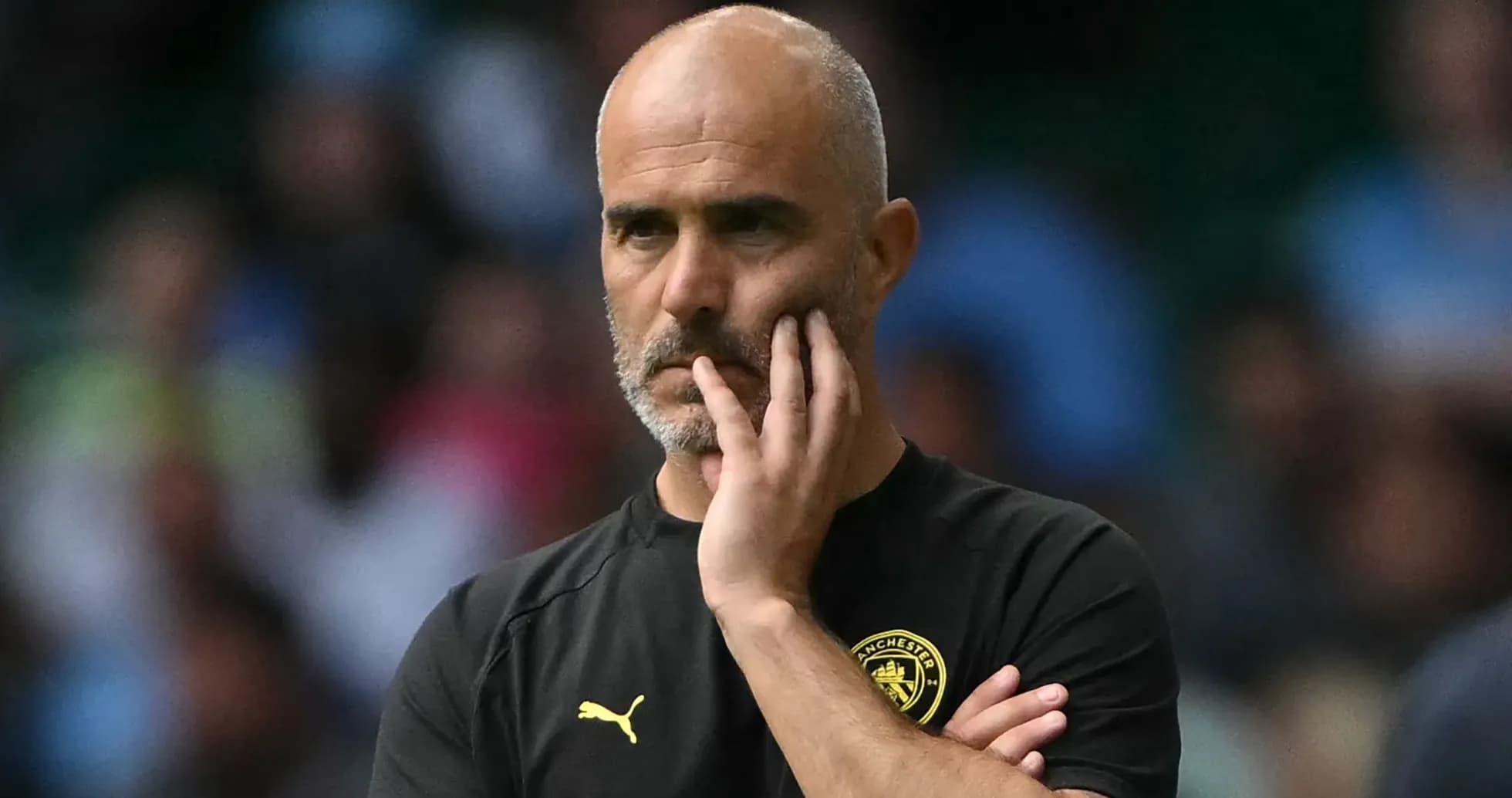 Manager observing the match with thoughtful expression Manager observing the match with thoughtful expression