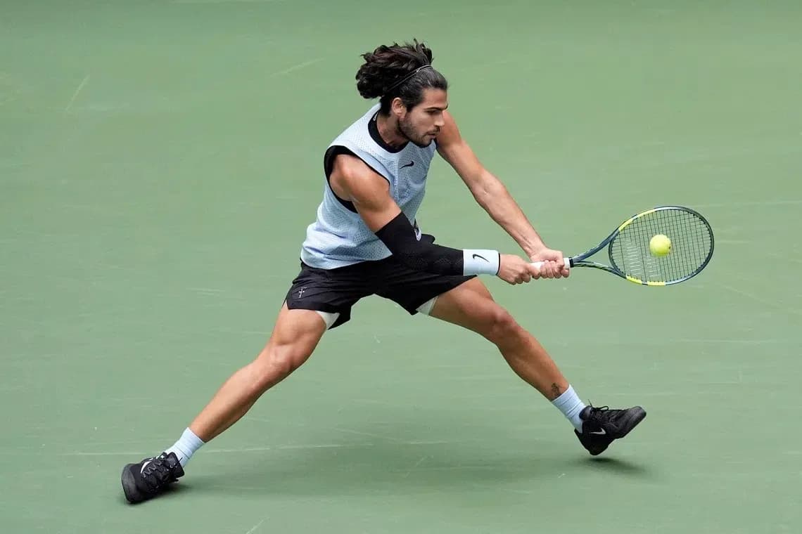 Tennis player executing a backhand stroke on court Tennis player executing a backhand stroke on court